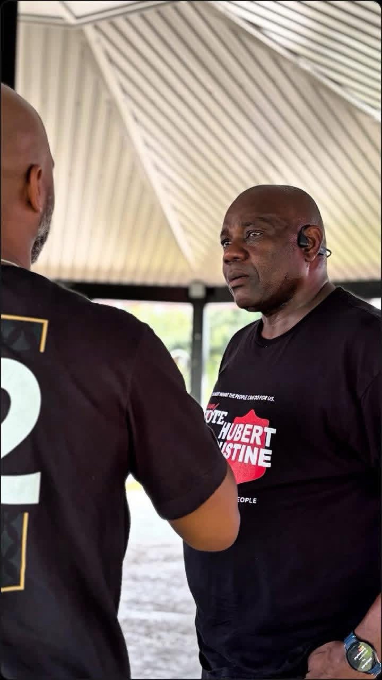 Hubert Augustine talking with a resident